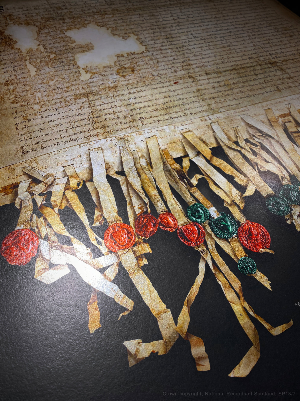 Black Onyx Burnished Gold fine-art photograph showing diagonal detail of the manuscript, parchment tags and wax seals.
