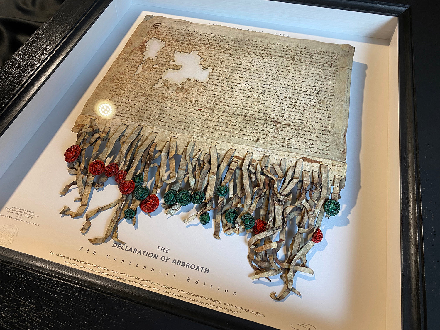 Declaration of Arbroath Fine-Art 3D Facsimile in dark charcoal frame, shown from a wider angled gallery view with the full lower seal area visible.