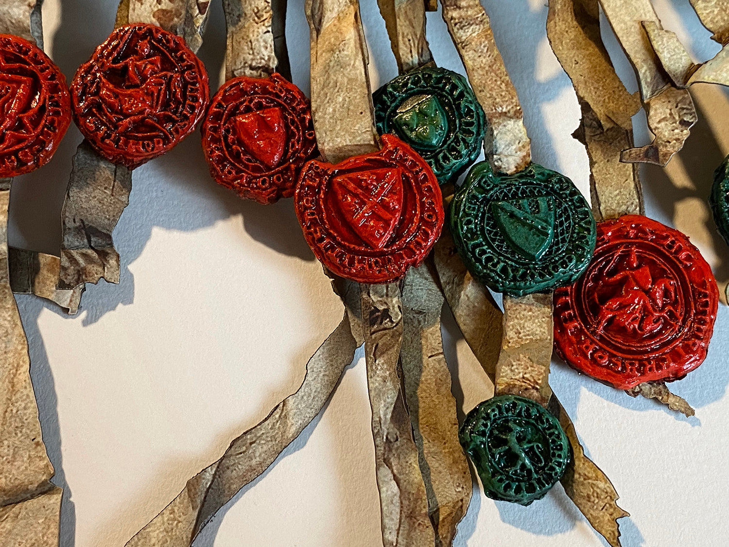 Close-up of red and green wax-seal-effect cast seals on the Declaration of Arbroath Fine-Art 3D Facsimile.