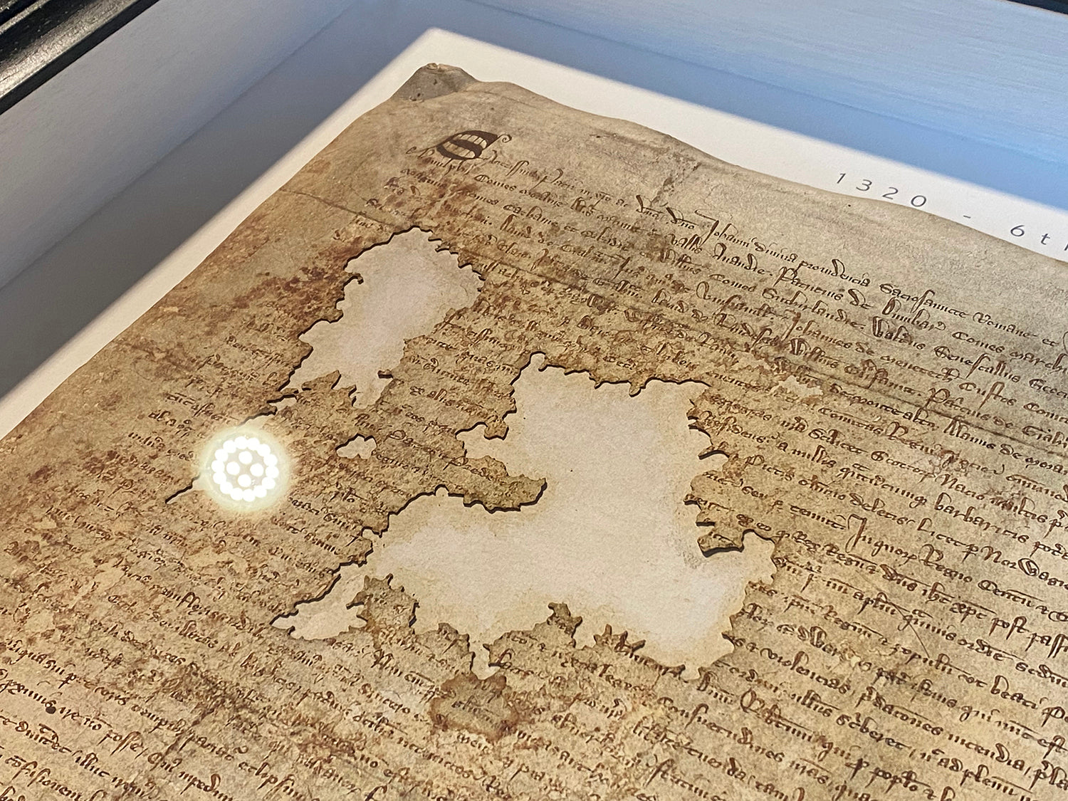 Close view of the manuscript surface and parchment damage detail on the Declaration of Arbroath Fine-Art 3D Facsimile.