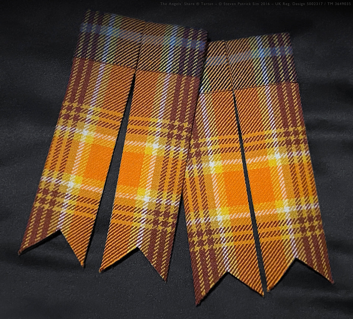 Pair of Angels’ Share tartan traditional kilt flashes shown with cut ends.