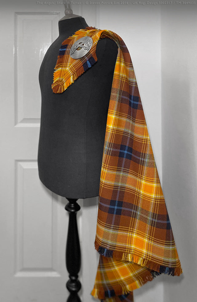 Full profile of The Angels’ Share fly plaid styled for Highland dress. A visual presentation of the fly plaid styled for formal Highlandwear, showcasing the tartan’s luminous palette and symmetry.