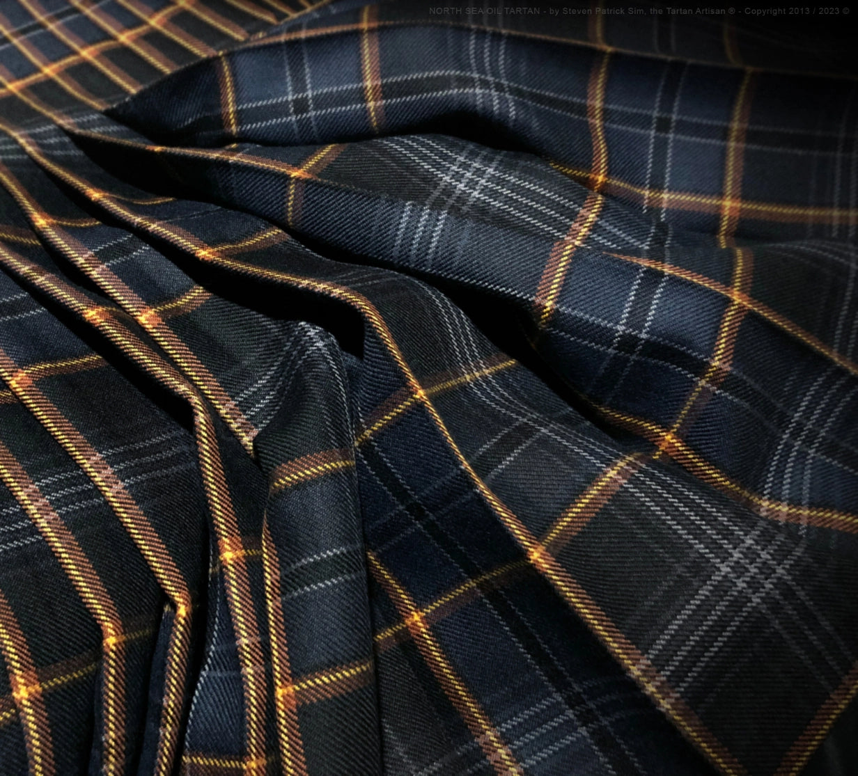 Macro view of the North Sea Oil tartan cloth texture and weave, showing the richness of colour, fibre density, and woven character of the fabric.
