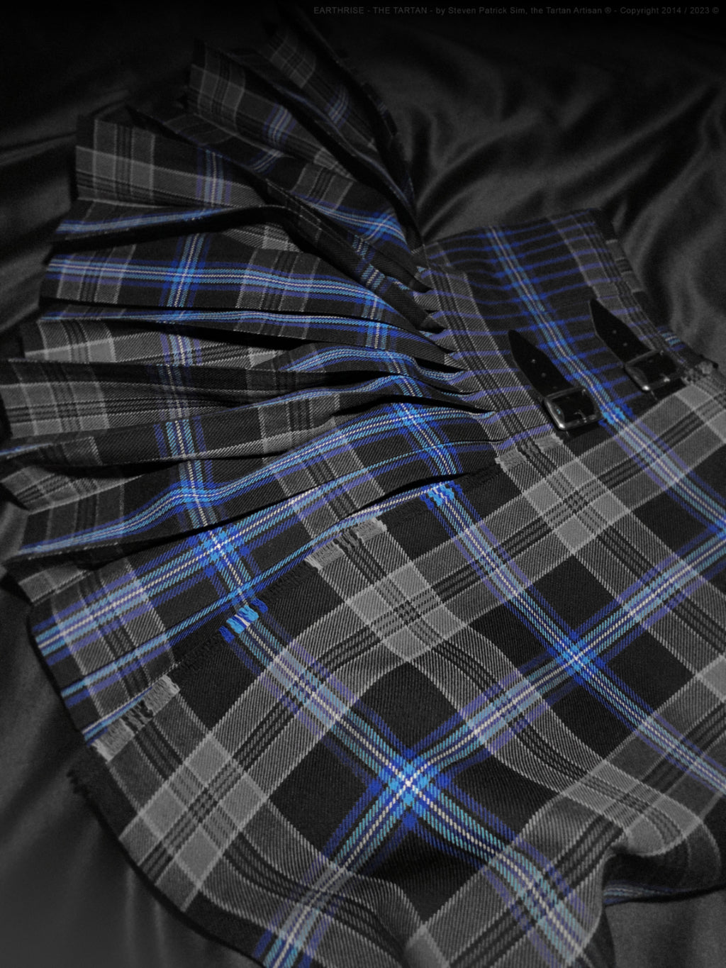A portrait-oriented display of the Earthrise kilt arranged for presentation, emphasising vertical flow and form.