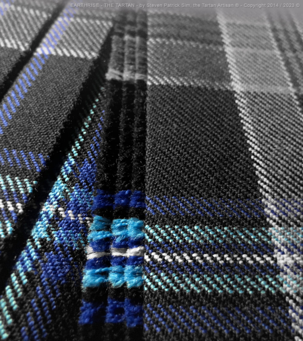 A triple-pleat detail of the Earthrise kilt, highlighting precision tailoring and alignment of the blue overchecks.