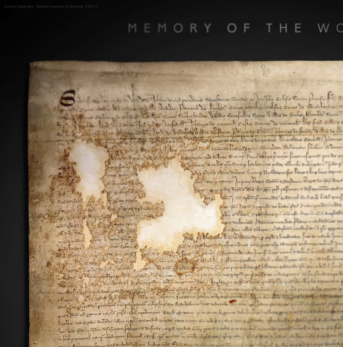 Close-up of the upper Black Onyx artwork showing medieval script, worn parchment and large areas of historic loss beneath the “Memory of the World” heading.