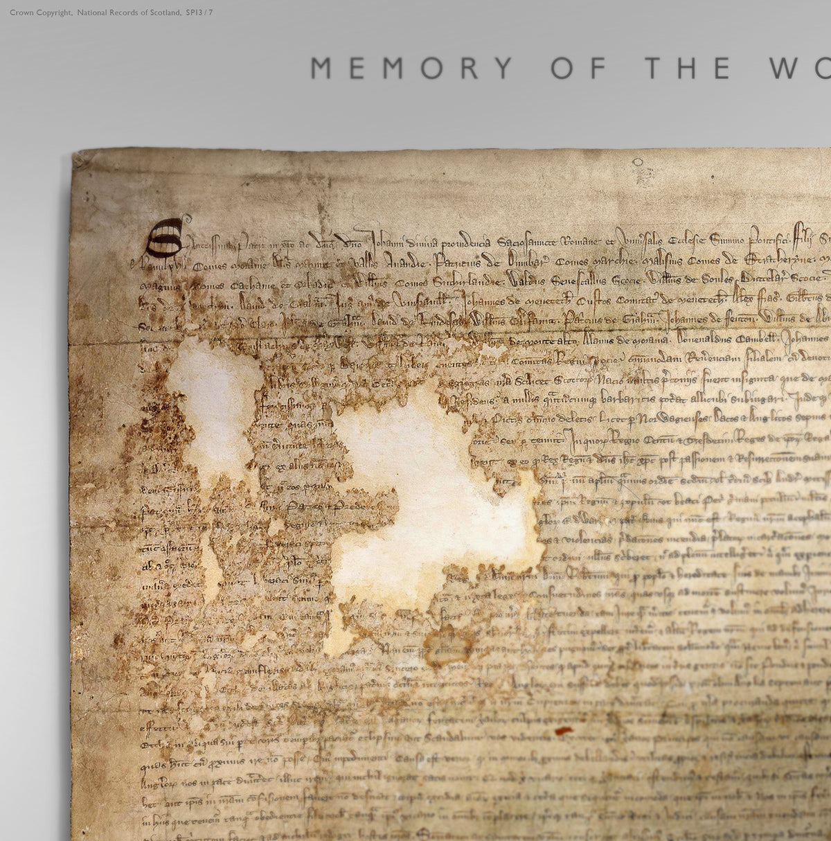 Close detail of the Pearl Burnished Gold Declaration of Arbroath print showing the upper manuscript, worn parchment surface and losses in the historic document beneath the “Memory of the World” heading.