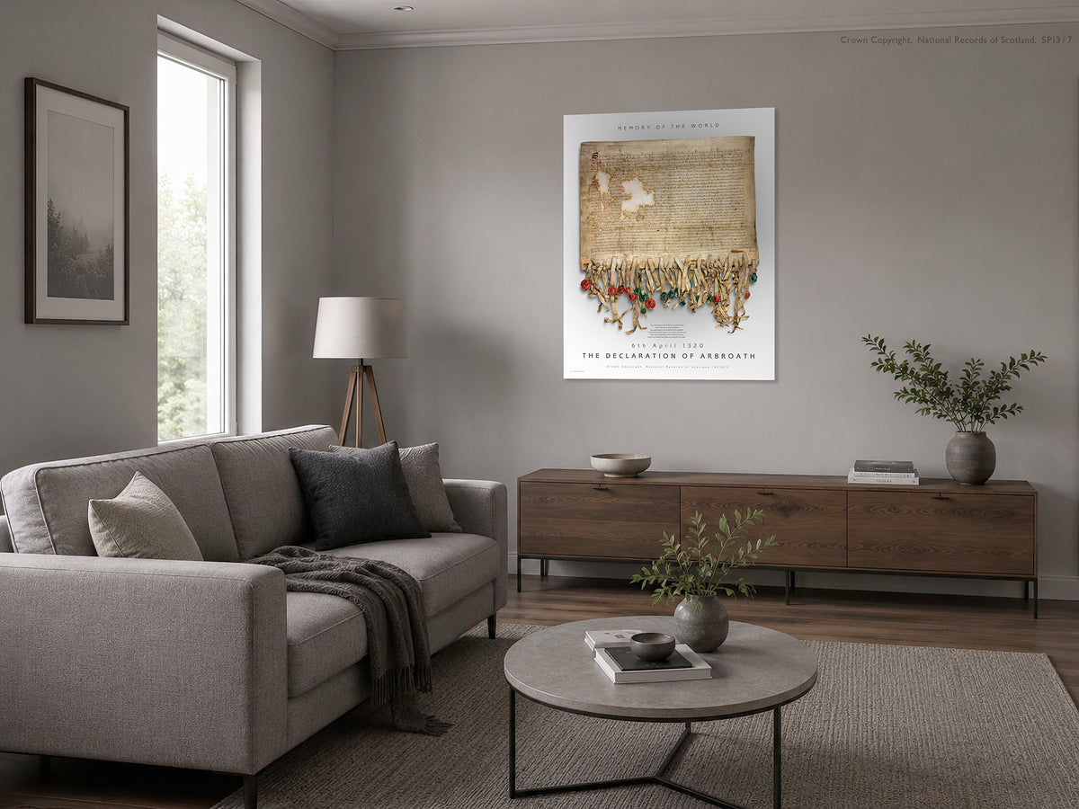 Illustrative soft neutral living-room interior showing the Pearl Burnished Gold Declaration of Arbroath artwork displayed on a light wall above a wooden sideboard beside a sofa.