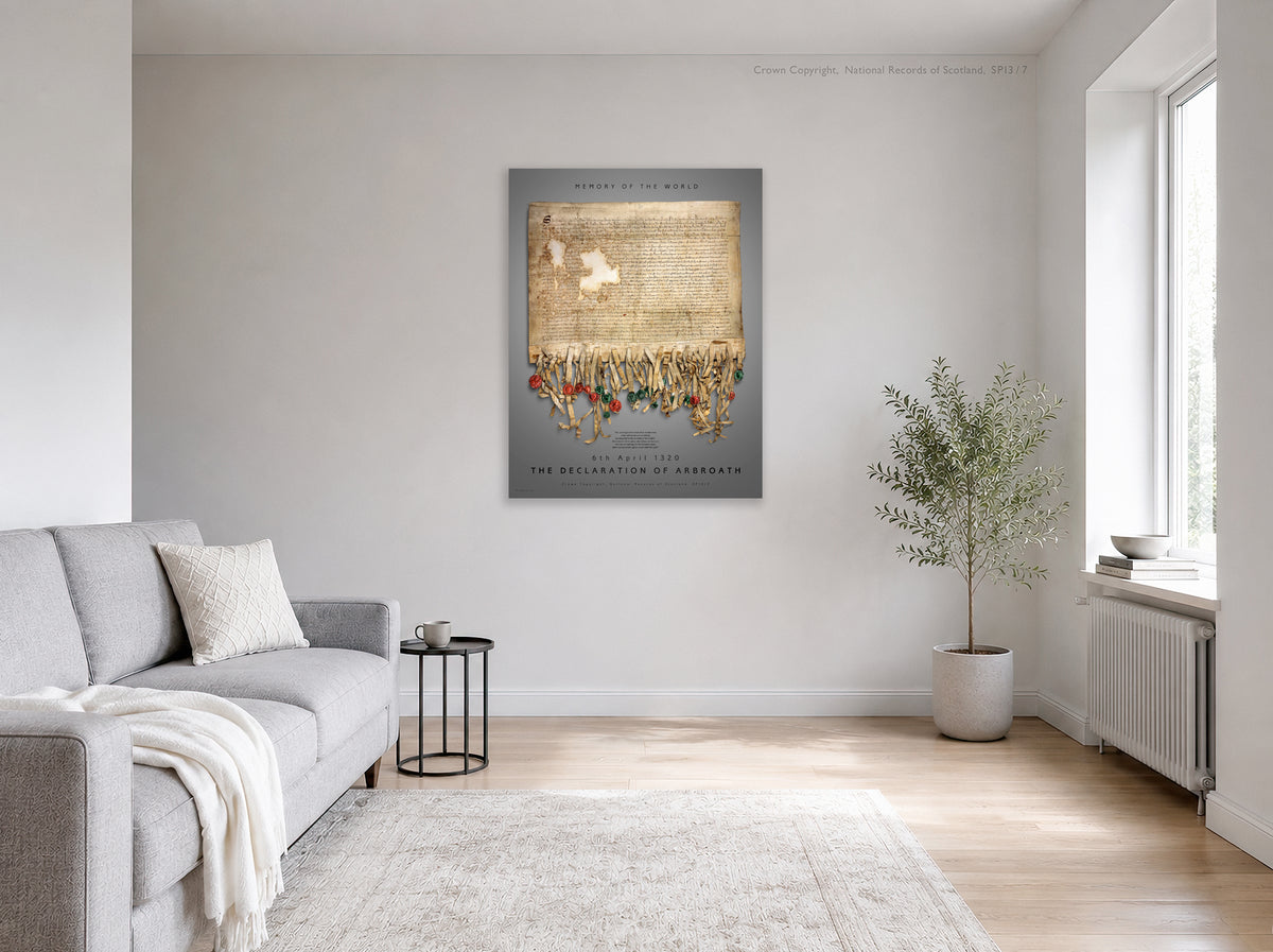 Illustrative bright living-room interior showing the Pewter Burnished Gold Declaration of Arbroath print displayed on a pale wall above a sofa, beside a plant and window.