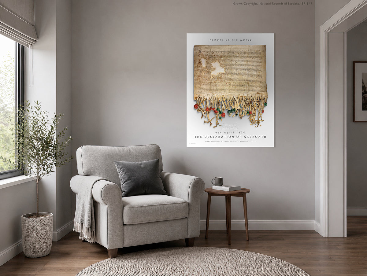 Illustrative neutral interior showing the Pearl Burnished Gold Declaration of Arbroath artwork displayed above an armchair beside a window, plant and small side table.
