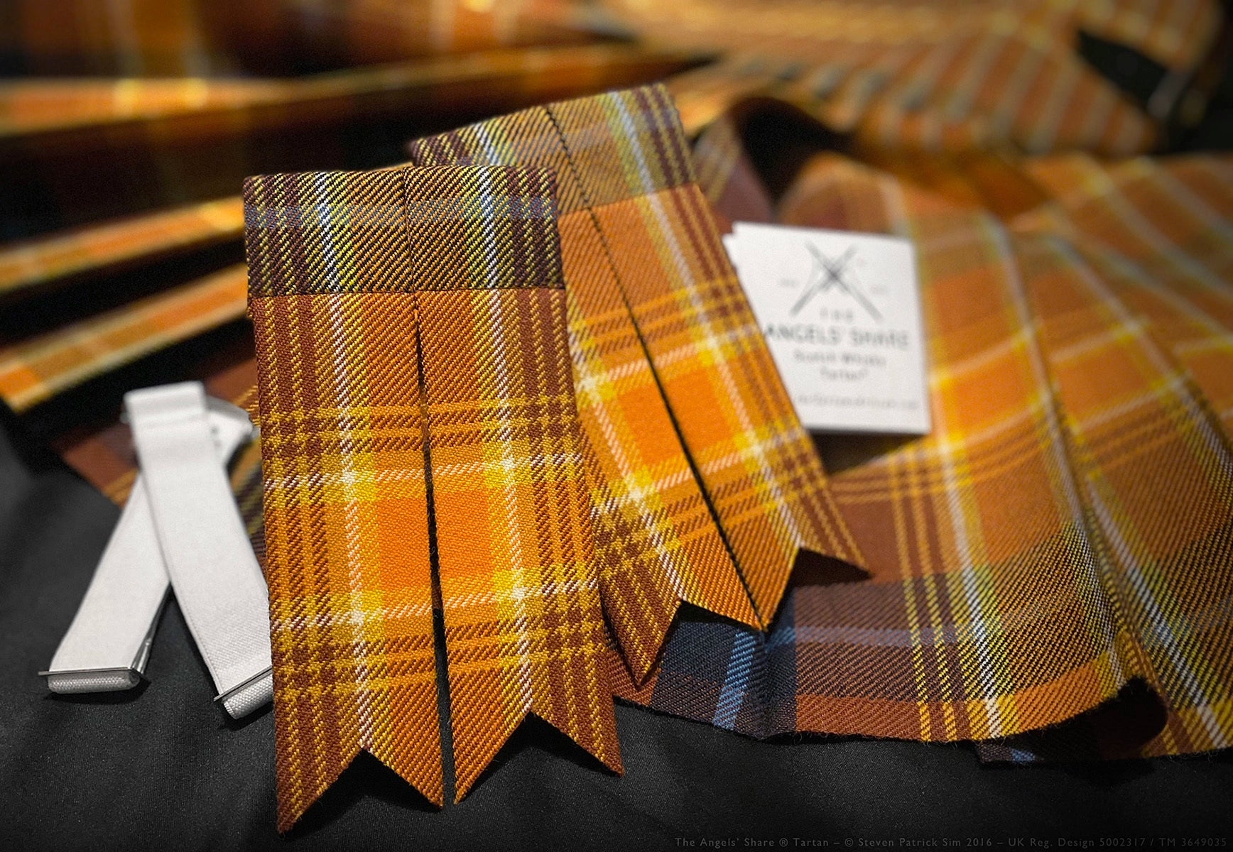 Angels’ Share tartan kilt flashes shown against a pleat-to-stripe kilt background.