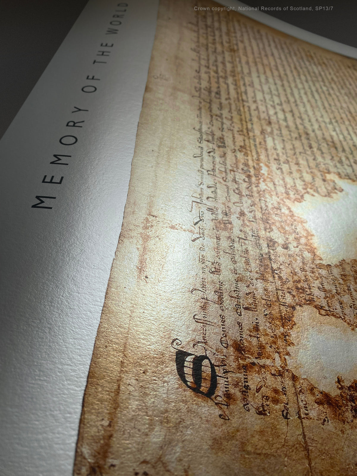 Pearl Burnished Gold fine-art print showing the Declaration of Arbroath manuscript and reflective metallic paper under changing light.