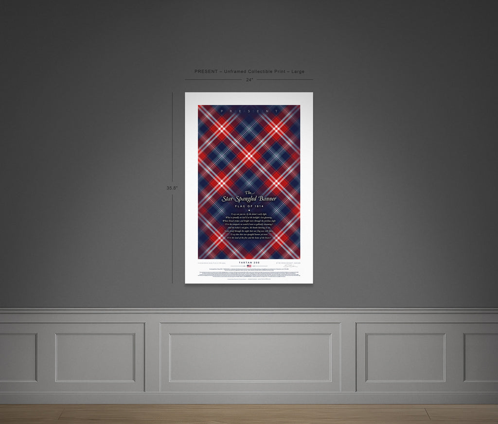 Full view of the large unframed Present Edition tartan print, mounted on a grey wall. The vivid scarlet, deep navy and white intersecting bands offer a bold reinterpretation of the modern U.S. banner in tartan form.