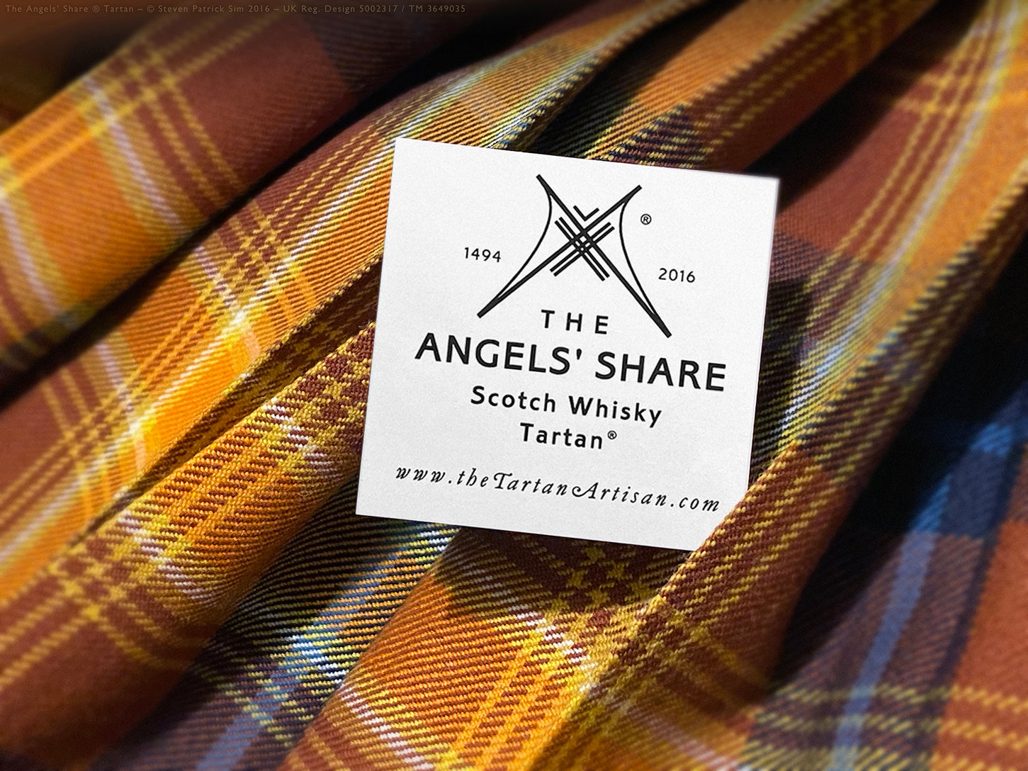 Macro detail of the Angels’ Share® tartan weave, showcasing golden and russet tones in soft folds. The ethereal weave of the Angels — a cloth that breathes light. The emblem derived from the sett.