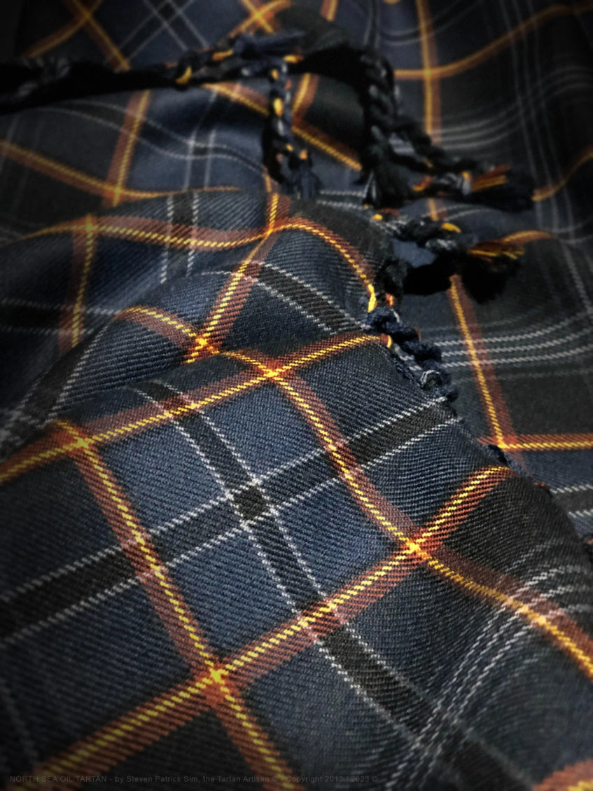Close study of the North Sea Oil tartan’s handwoven texture, highlighting fibre variation, weave consistency, and surface character.