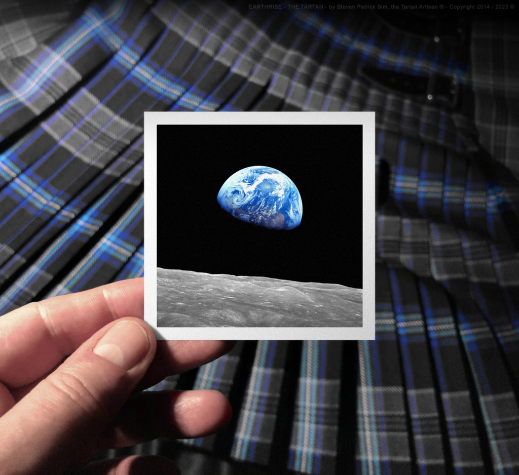 A hand-held photograph of the Earthrise image held against the pleated tartan, connecting human scale to cosmic inspiration.